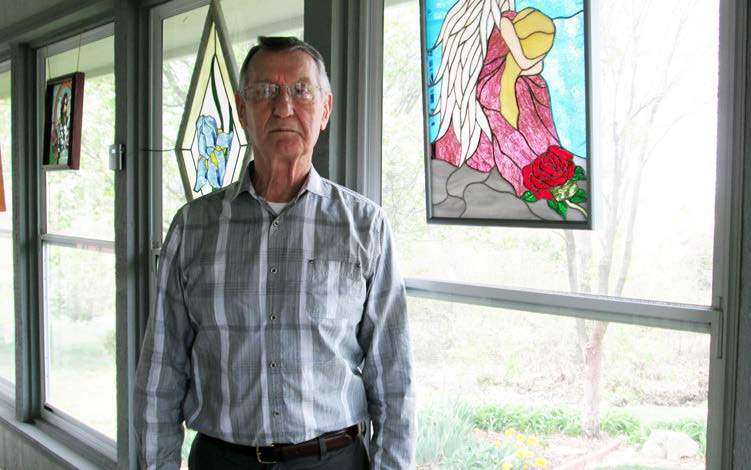 Jim Dillman and his stained glass artwork.<br /> Photo courtesy Emporia Gazette.