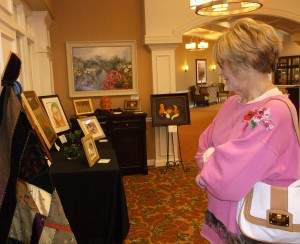 Beverly Anderson views artwork at the Art is Ageless exhibit.