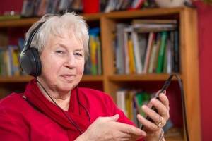 A resident listens to music through a mobile device.