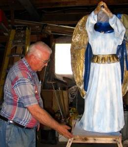 Jim VanDyke restores an angel that is part of Presbyterian Manor's nativity collection.