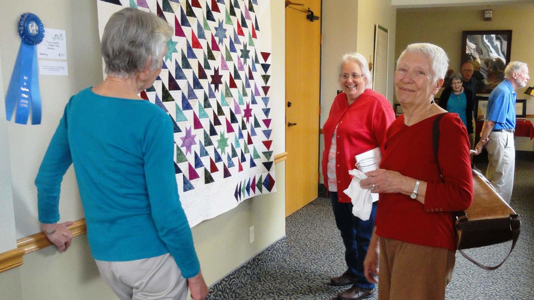 Residents and guests enjoy the Art is Ageless Exhibit at Newton Presbyterian Manor.