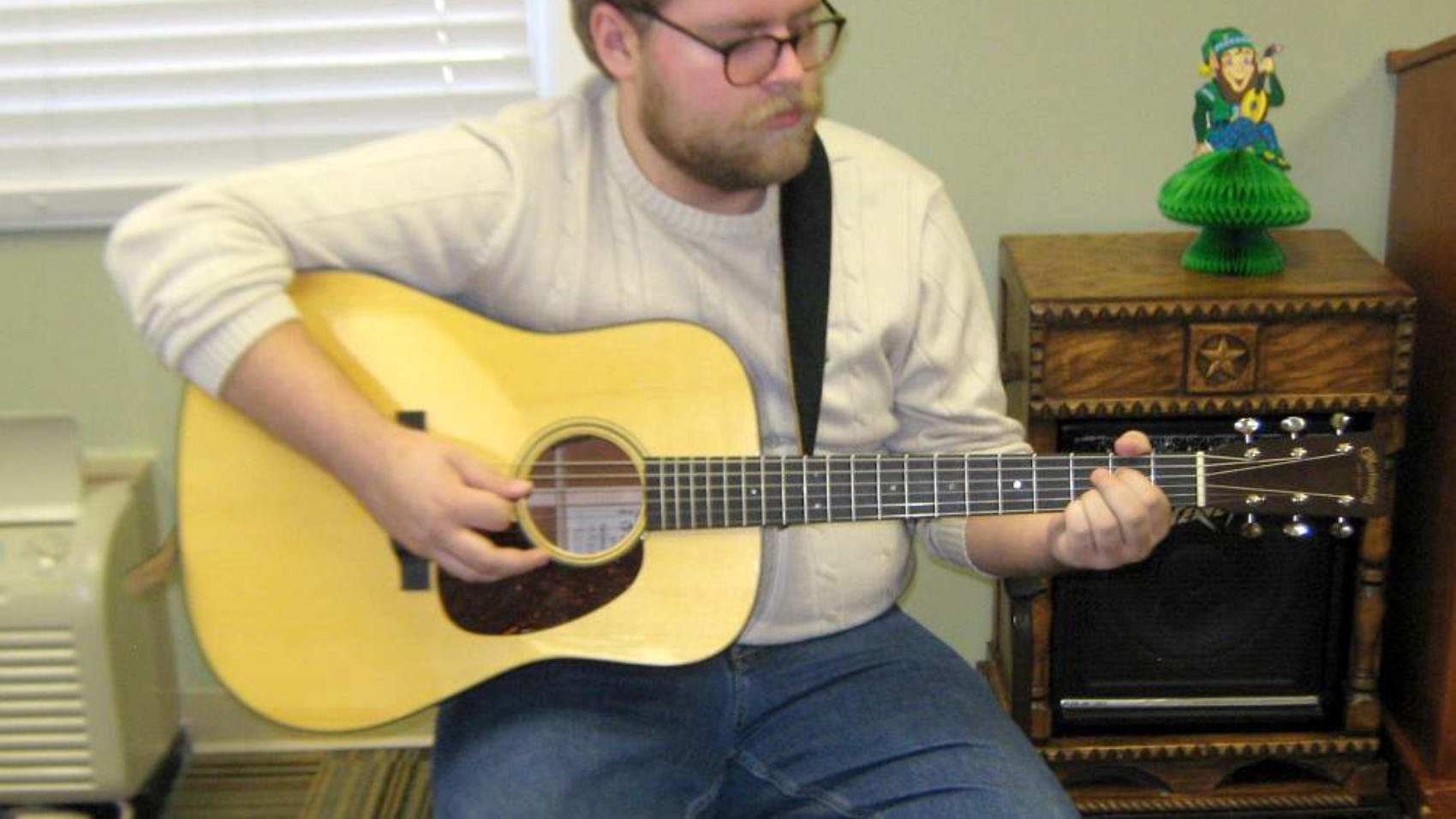 Rolla High School graduate Thomas Hardwick plays the guitar to residents at Rolla Presbyterian Manor.