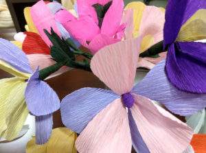 Residents at Valley Glen help create colorful paper flowers made with fancy crepe paper and other supplies.