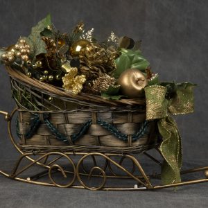 Christmas Forever - Sleigh basket containing gold Christmas ornaments and pinecones finished off with green bow