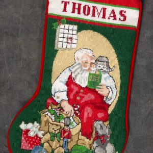 Christmas - Thomas Christmas Stocking - Needlepoint stocking with the name Thomas stitched across top with Santa Claus sitting by gifts and checking his list