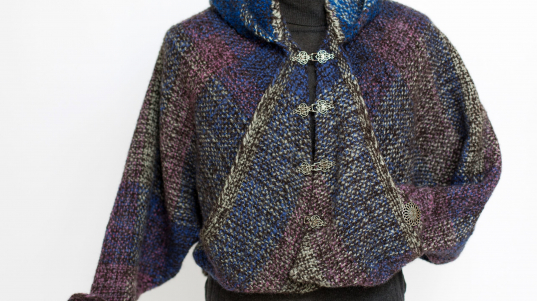 A woven wool jacket in blue, magenta, black and tan.