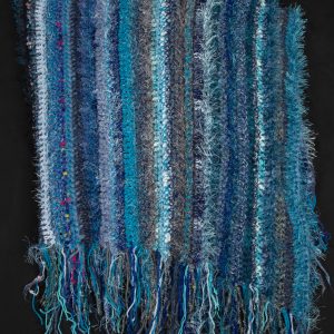Fiber Arts - Memories of Mom in Blue - Blue throw made out of several textures of yarn to give it a very soft look and feel finished off with fringe on the top and bottom end.