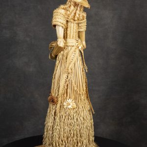 Fiber Arts - Our Victorian Lady of Kansas - Detail - Victorian female woven out of wheat with intricate design on bodice on dress. Curled hair and hat woven out of wheat with female holding purse woven out of wheat.