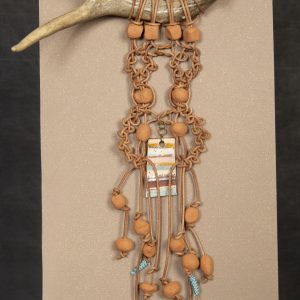 Fiber Arts - Repurposed Memories - Deer antler with hanger and macrame cords attached to it with clay beads and rectangular shaped charms painted with various colors.