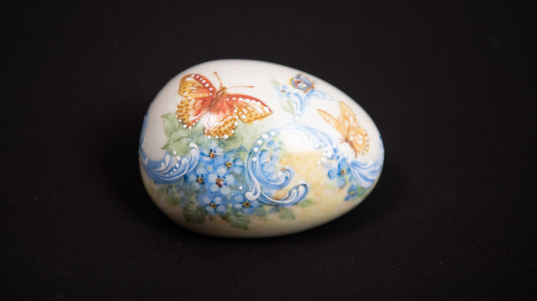 Egg shape painted with butterflies and flowers
