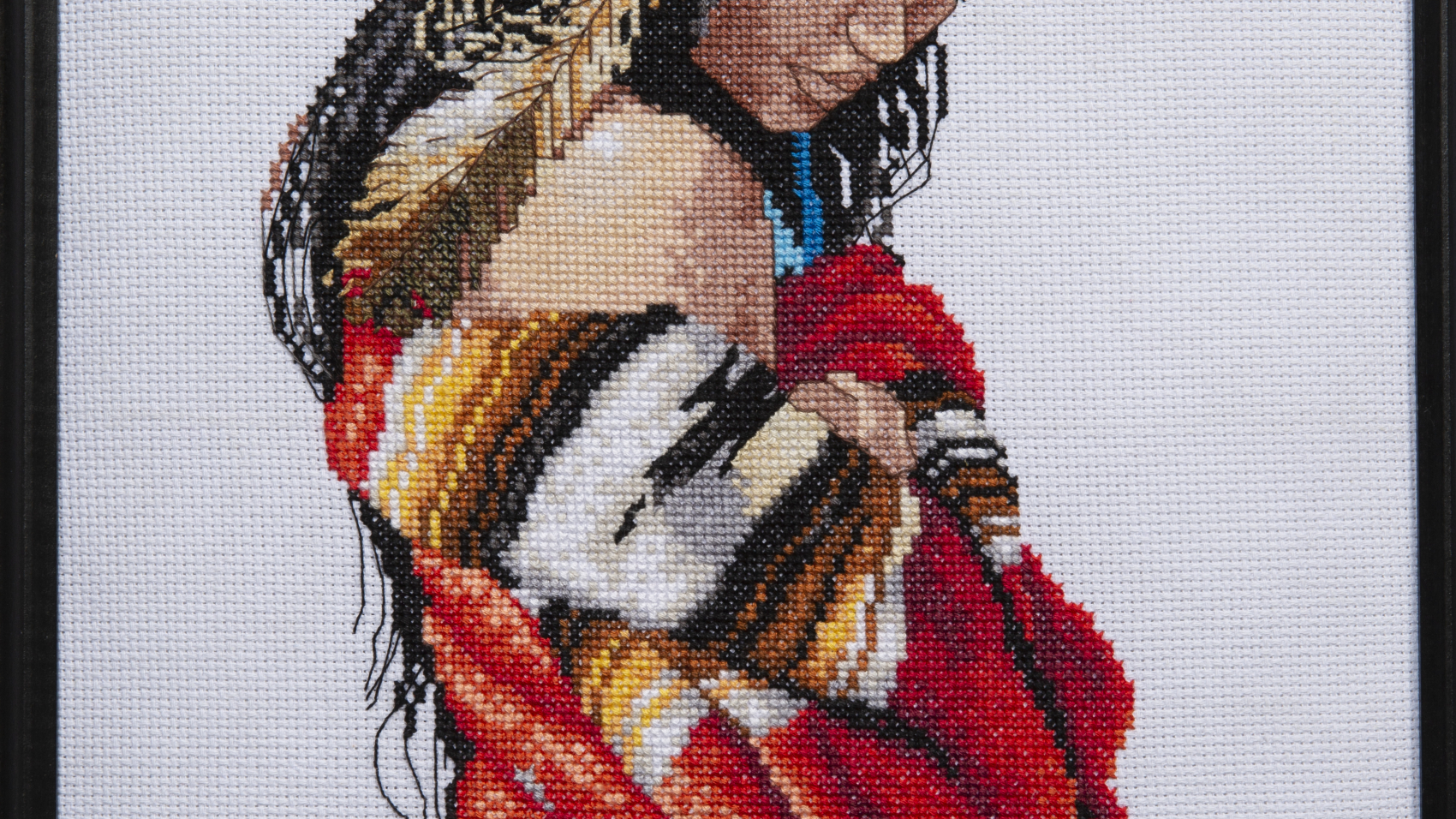 Needlework - Indian Maiden - needlework of young indian maiden with various feathers in her hair and wrapped in colorful red, yellow, white and black blanket.