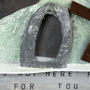 Sculpture 3D - He is Risen - Detail - large sculpture of empty tomb of Jesus with wooden cross next to tomb opening with the words 