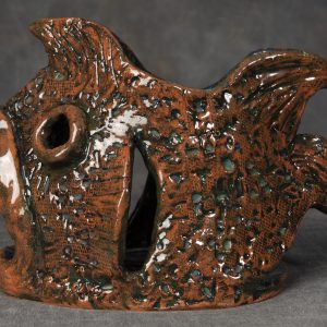Sculpture 3D - Terri Ann Fishsinger - Detail - sculpture of a fish made from ceramic or clay that has various design elements on the body and fins. The mouth of the fish is very large and is open, as well as an opening on the top and through the eyes.