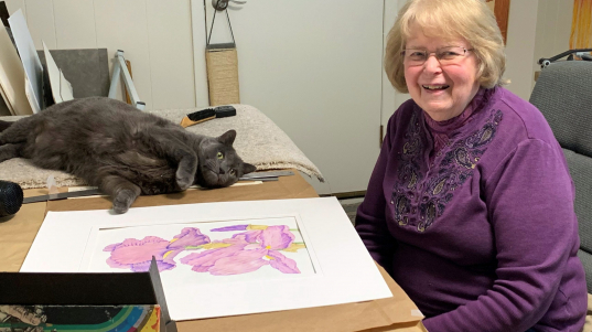 Betty works in her studio at home with Bobo the cat.