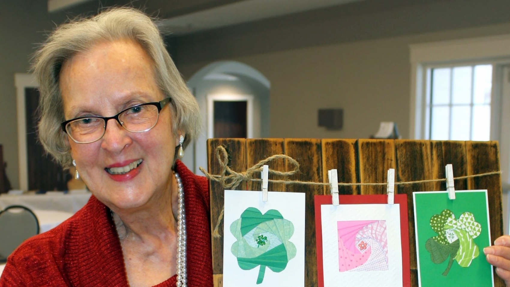 Joan Hampton with her mixed-media piece, “Cards to Share,” that’s featured in the 2022 Art is Ageless calendar.